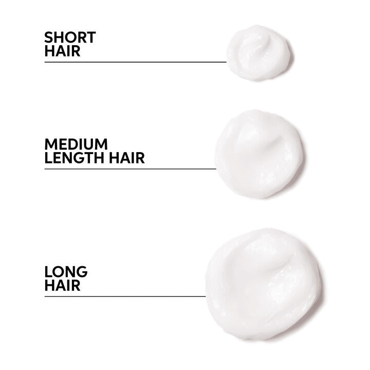 Hair stylist applying Wella Oil Reflections Reboost Mask to client’s hair