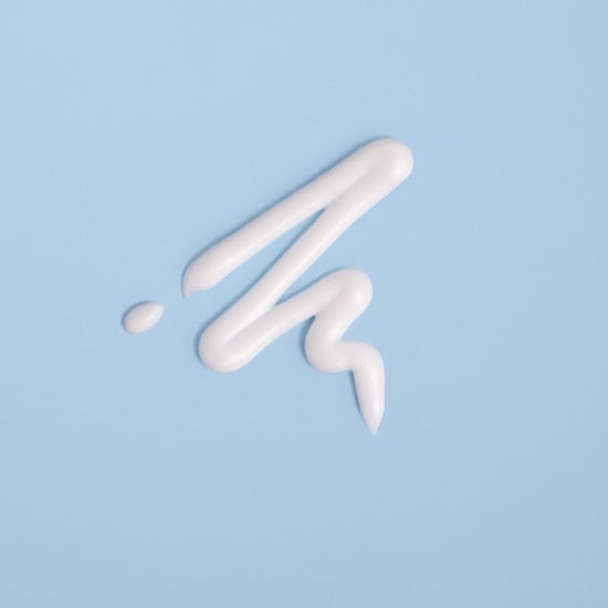 White cream or paint on a light blue background