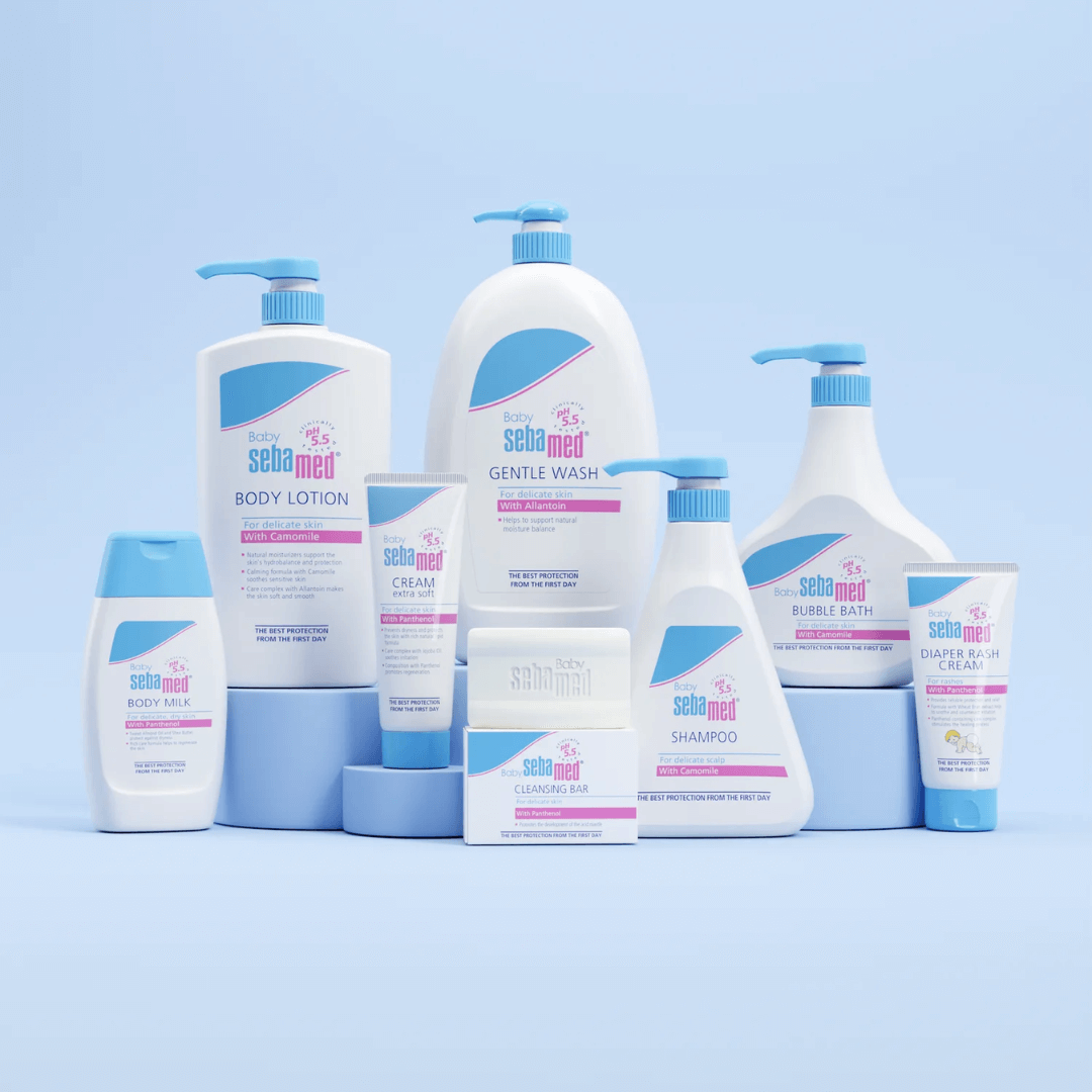 Collection of Sebamed baby care products on a light blue background