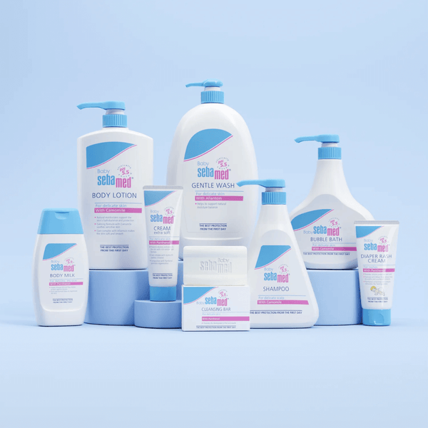 Collection of Sebamed baby care products on a light blue background